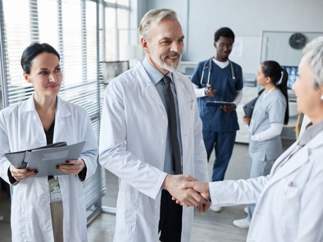 smiling-experienced-hospital-worker-shaking-hand-o-2025-03-08-03-07-41-utc (1)